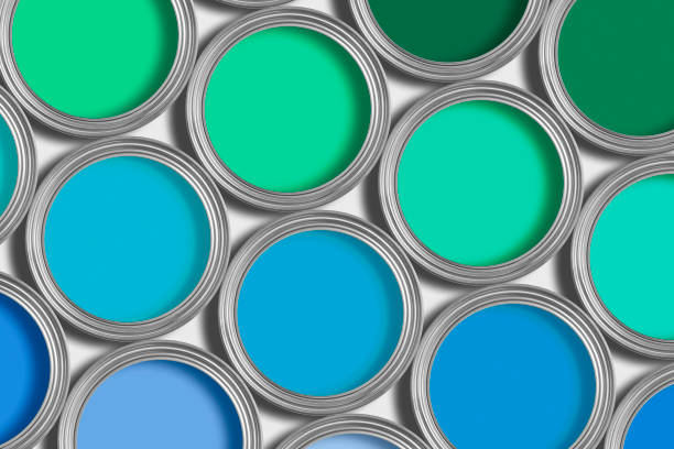 istock Open tins of blue and green paint on white 126260816