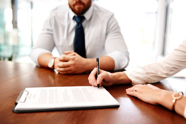 istock Sitting down to sign an agreement between two parties 1262611979