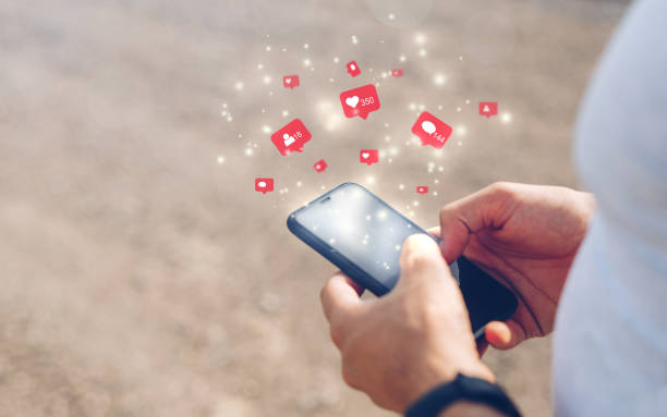 Male hands using mobile smartphone with icon social media and social network. Marketing concept.