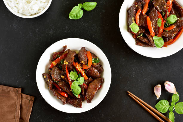 istock Thai beef stir-fry with pepper and basil in bowl 1262615076