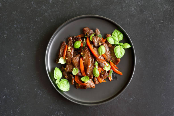 istock Thai style stir-fry beef with vegetables on plate 1262615152