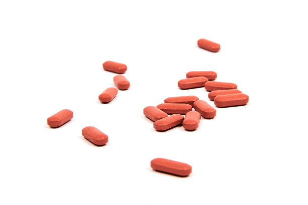 istock Take your pills - Red pills against white background 1262616847