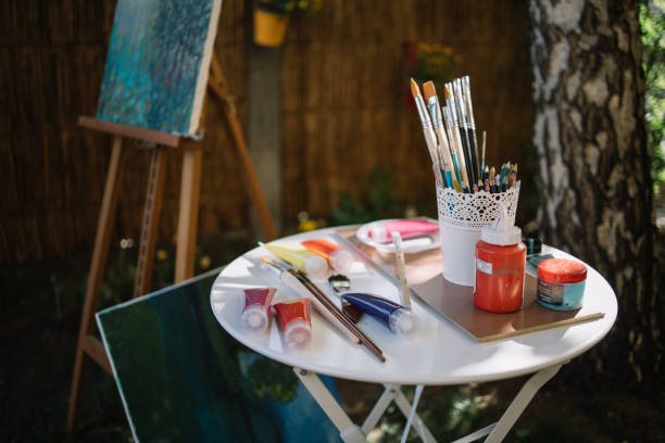 istock Paint tubes and brushes on table outdoor 1262621057