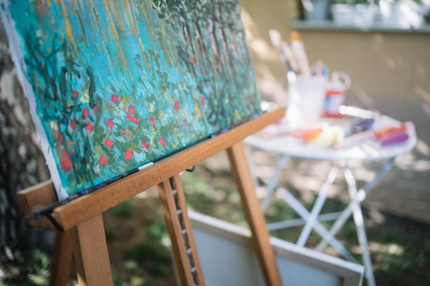 istock Close-up view of tripod with painted canvas 1262621102