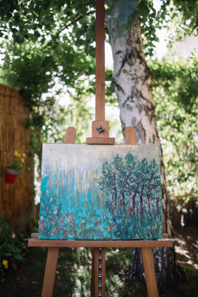 istock Tripod with painting on canvas in nature 1262621198