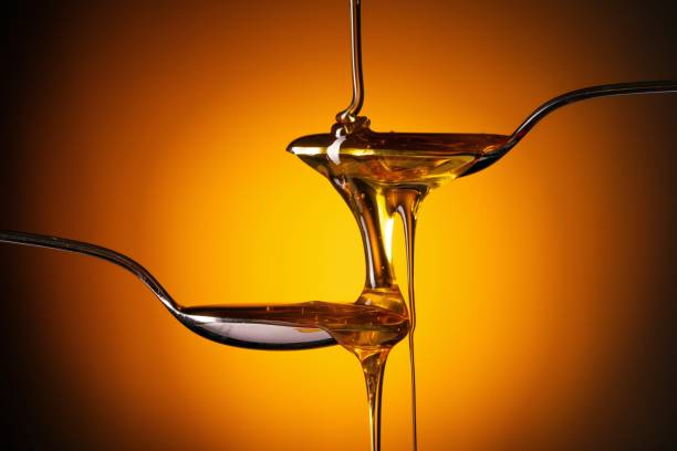 istock Organic honey flowing from the spoon 1262622804