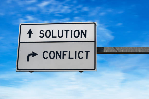 istock Solution versus conflict. White two street signs with arrow on metal pole 1262626699
