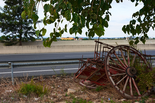 A destroyed horse cart in front of a paved road