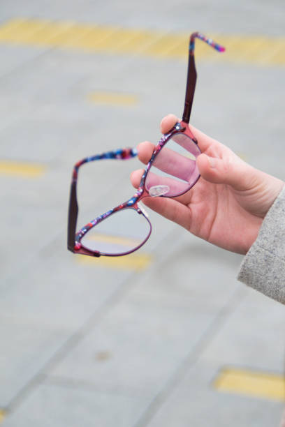 istock Reading glasses in woman's hand. 1262629252