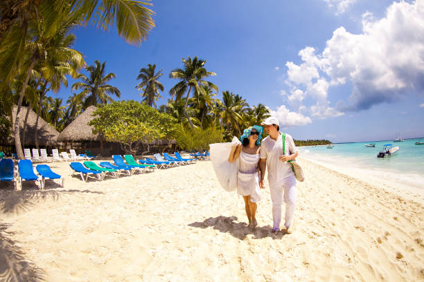 istock tourists walk through empty sandy sea beach. 1262630568