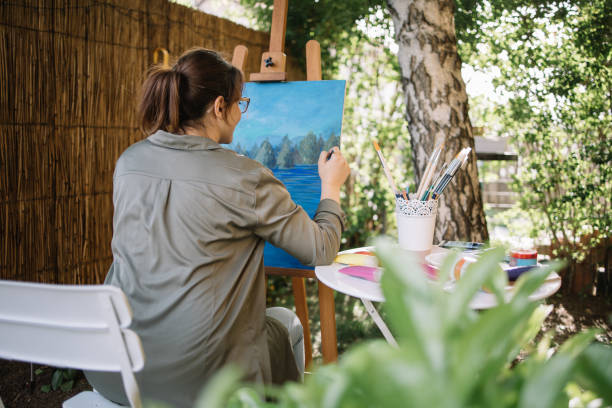 istock Lady painter drawing with brush and paint 1262631333
