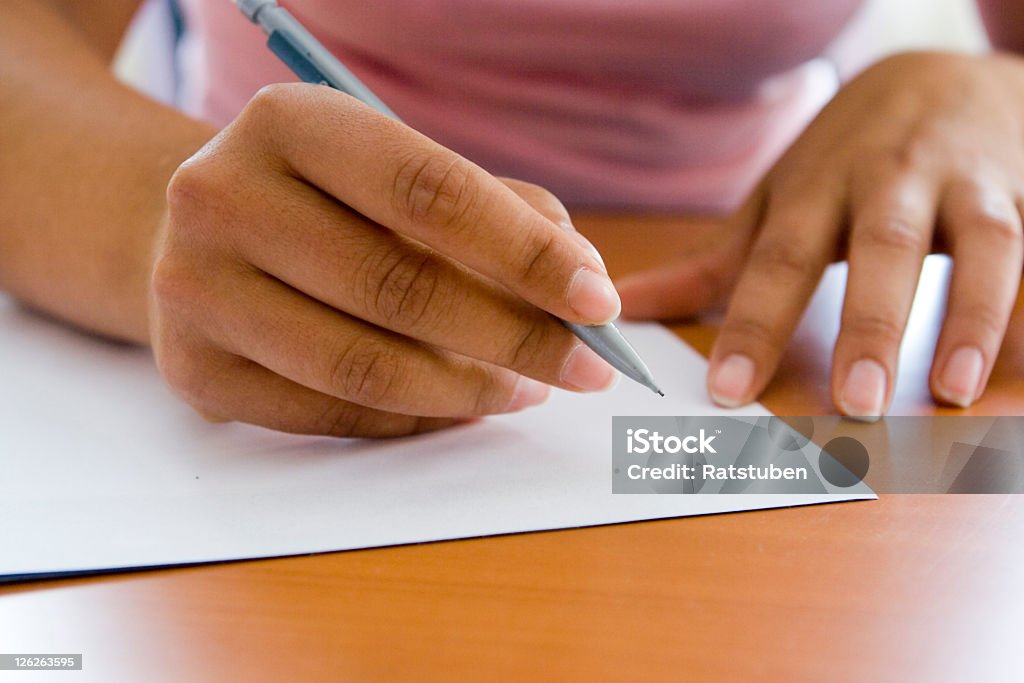 Close-up of adult hands writing with pen and paper Secretary about to start Shorthand dictation.. Letter - Document Stock Photo
