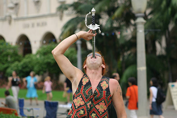 Street entertainer swallowing a sword stock photo