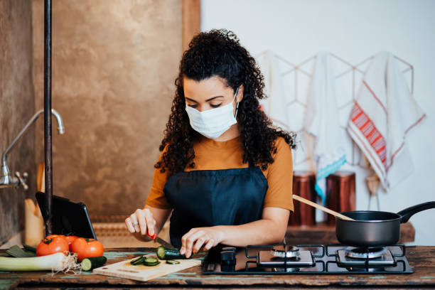 istock Woman in the kitchen preparing food 1262639810
