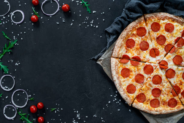 istock Pepperoni Pizza On Black Background With Cooking Ingredients, Empty Space For Recipe 1262640000