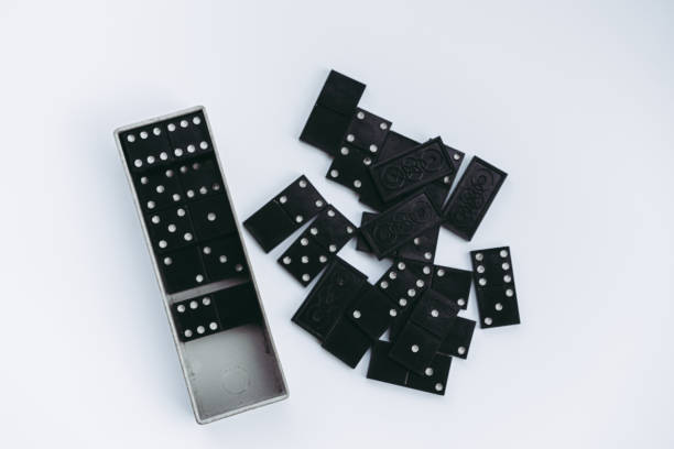istock Dominoes lie on a white background 1262649654