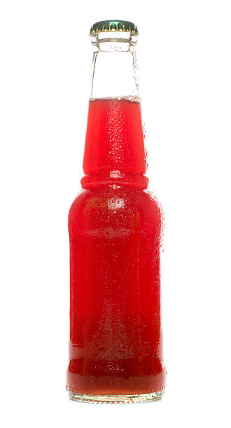 Glass bottle of red drink on white background stock photo