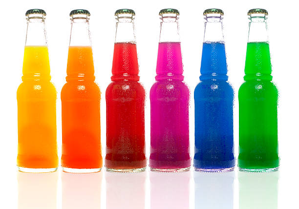 Row of multi colored bottles on white backgound stock photo