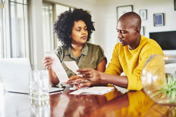 istock Couple sitting at a table and going over their household finances 1262653837