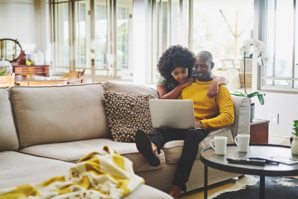 istock Content couple using a laptop in their living room 1262653945