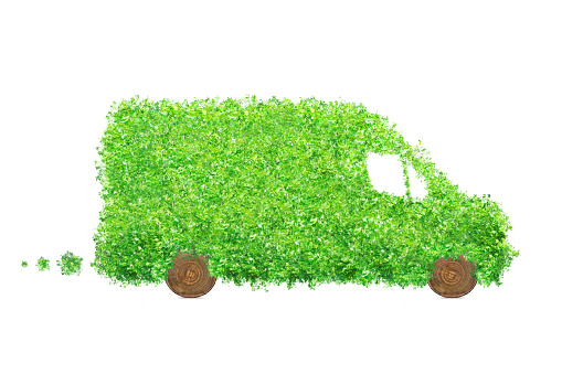 Isolated delivery van made of leaves and wood. Electric cargo car, transportation and environmental concept.