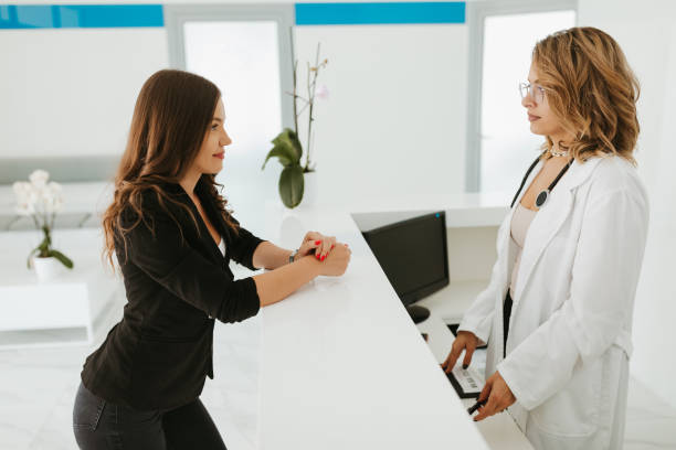 istock Receptionist of clinic talking with patient 1262654255