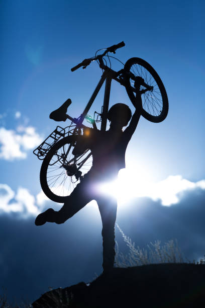 istock Happy cyclist woman silhouette 1262656323