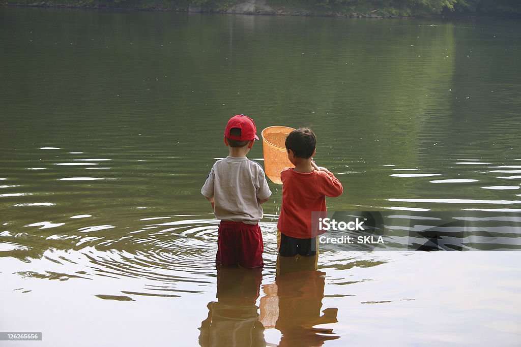 Children playing at the water/like, childhood memories  Child Stock Photo