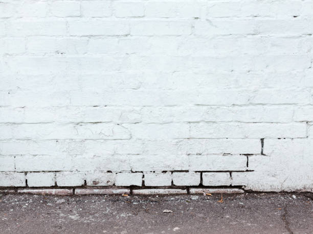 istock Brick wall, weathered, worn wall damaged paint. Grunge Concrete Surface. Great background or texture. 1262657584