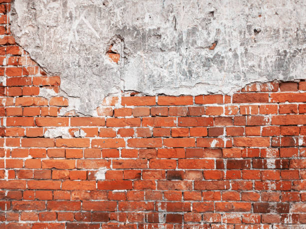 istock Brick wall, weathered, worn wall damaged paint. Grunge Concrete Surface. Great background or texture. 1262657590