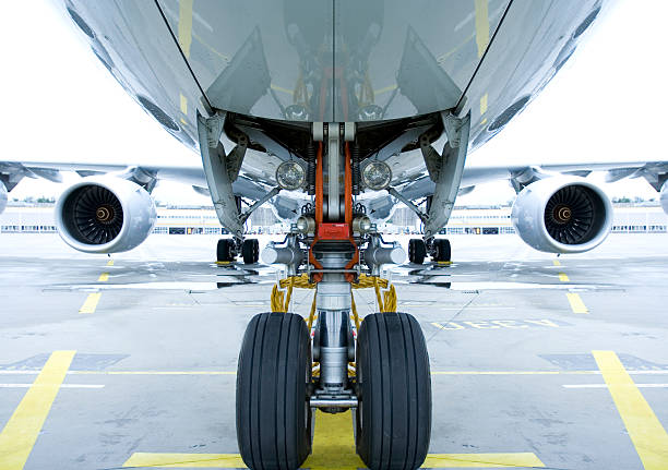 Landing gear shown in use under airplane  stock photo