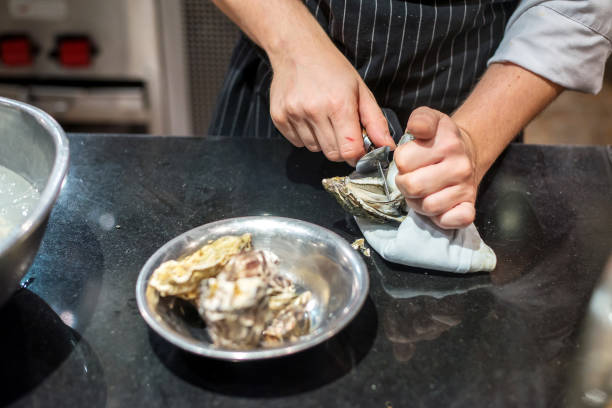 istock Chef opened fresh oyster in restaurant kitchen 1262660370
