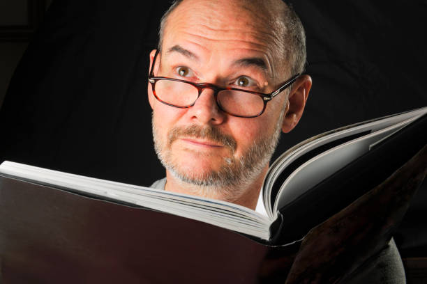istock One Mature Man Reading Book with Facial Expression 1262662685