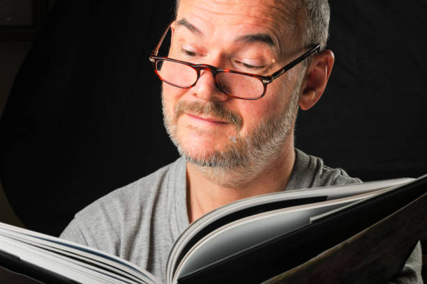 istock One Mature Man Reading Book with Facial Expression 1262663844