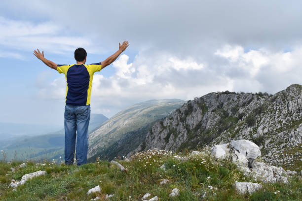 istock Man hiking in the mountains on a summer day 1262663905