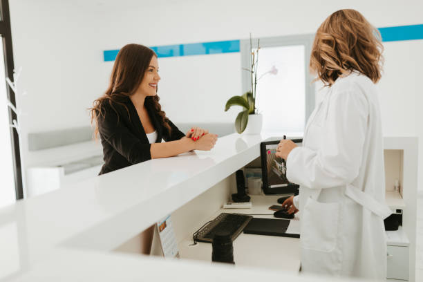 istock Receptionist of clinic talking with patient 1262664123