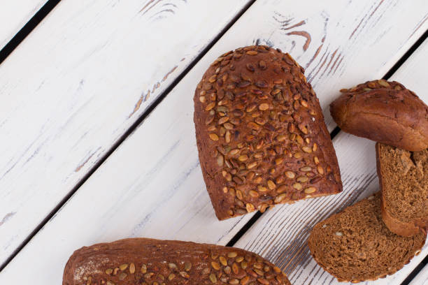 istock Whole grain bread on wooden background. 1262665401