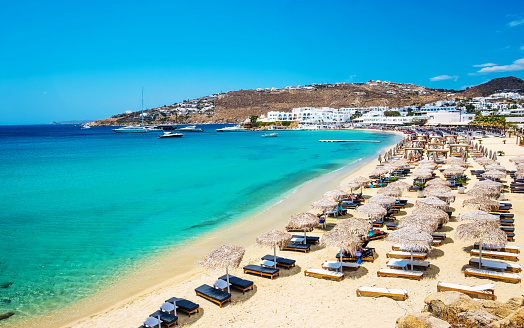 Beautiful beach of Mykonos with deck chairs and umbrellas, Greece