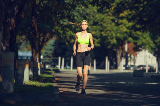 istock Female runner, athlete training outdoors in summer's sunny day. 1262669020