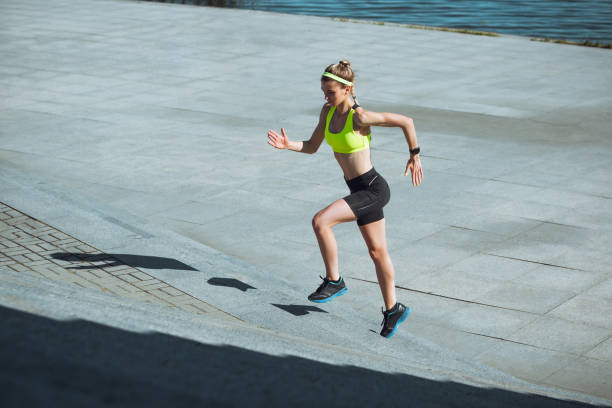 istock Female runner, athlete training outdoors in summer's sunny day. 1262669025