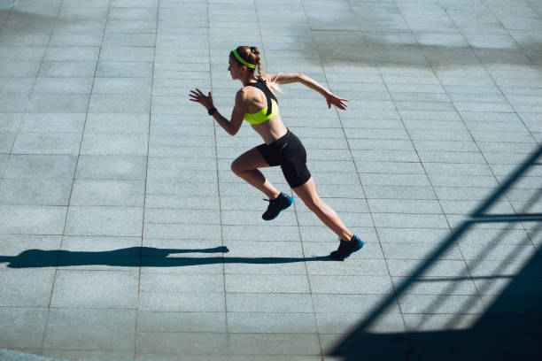 istock Female runner, athlete training outdoors in summer's sunny day. 1262669079