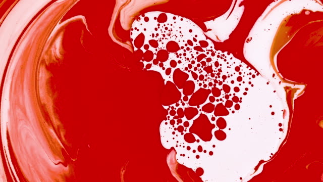 Abstract red blood paint bubbles marble background with milk oil and soap. Colored inks in water texture reaction