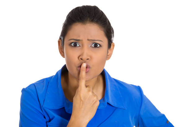 istock serious woman placing finger on lips asking for silence 1262670497