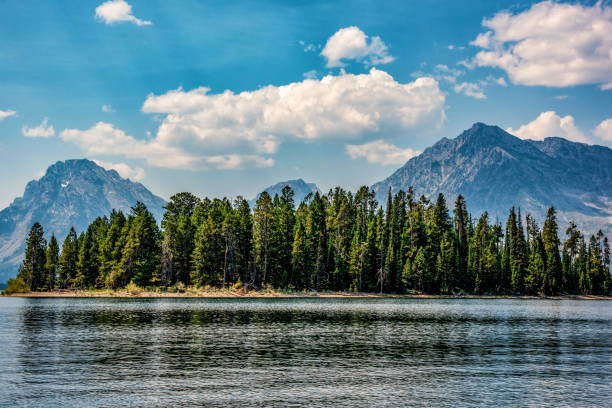 The view of the majestic peaks of the Teton Mountain Range in Grand Teton National Park beyond Jackson Lake on a warm, late summer afternoon.