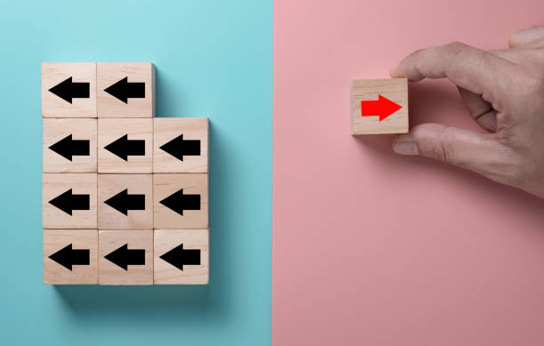 istock Red arrow print screen on wooden cube changing direction with black arrow. It is business disruption and different thinking idea concept. 1262672321