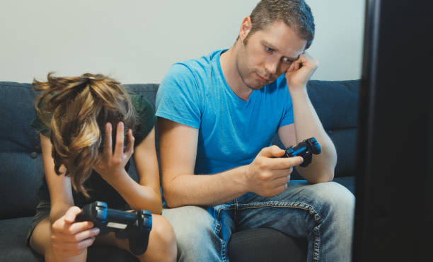 istock Dad and his daughter playing console game with wireless joysticks. Game over. 1262673831