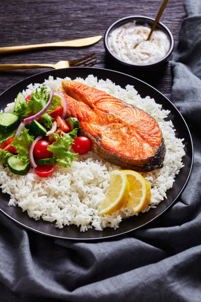 istock fried trout steak served with rice and vegetable salad 1262674226