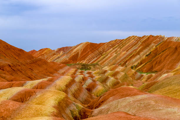 Zhangye Danxia National Geological Park Amazing scenery of Rainbow mountain and blue sky background in sunset. Zhangye Danxia National Geopark, Gansu, China. Colorful landscape, rainbow hills, unusual colored rocks, sandstone erosion zhangye danxia geopark china stock pictures, royalty-free photos & images