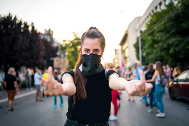 istock Young woman protester showing middle finger 1262679951