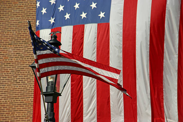 istock American flag hanging from a building (USA) 126267999